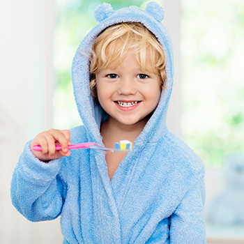Boy holding a toothbrush